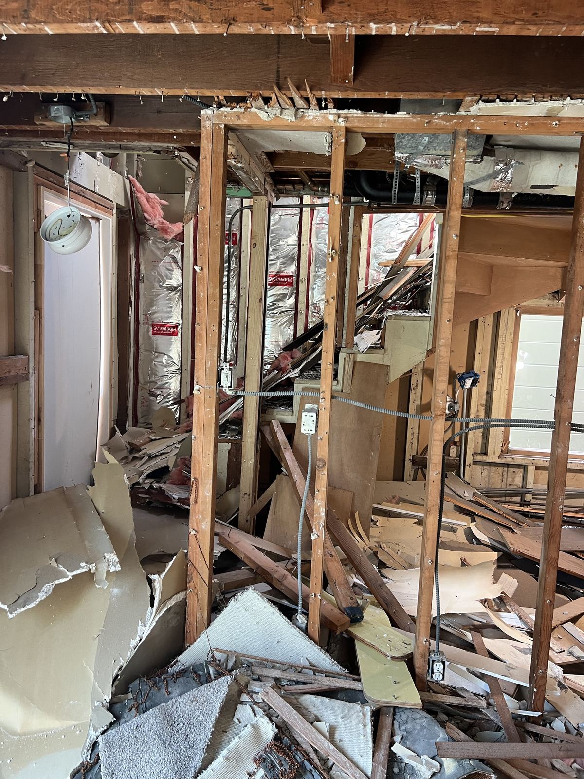 Demolition debris and exposed framing during full home gut in San Francisco
