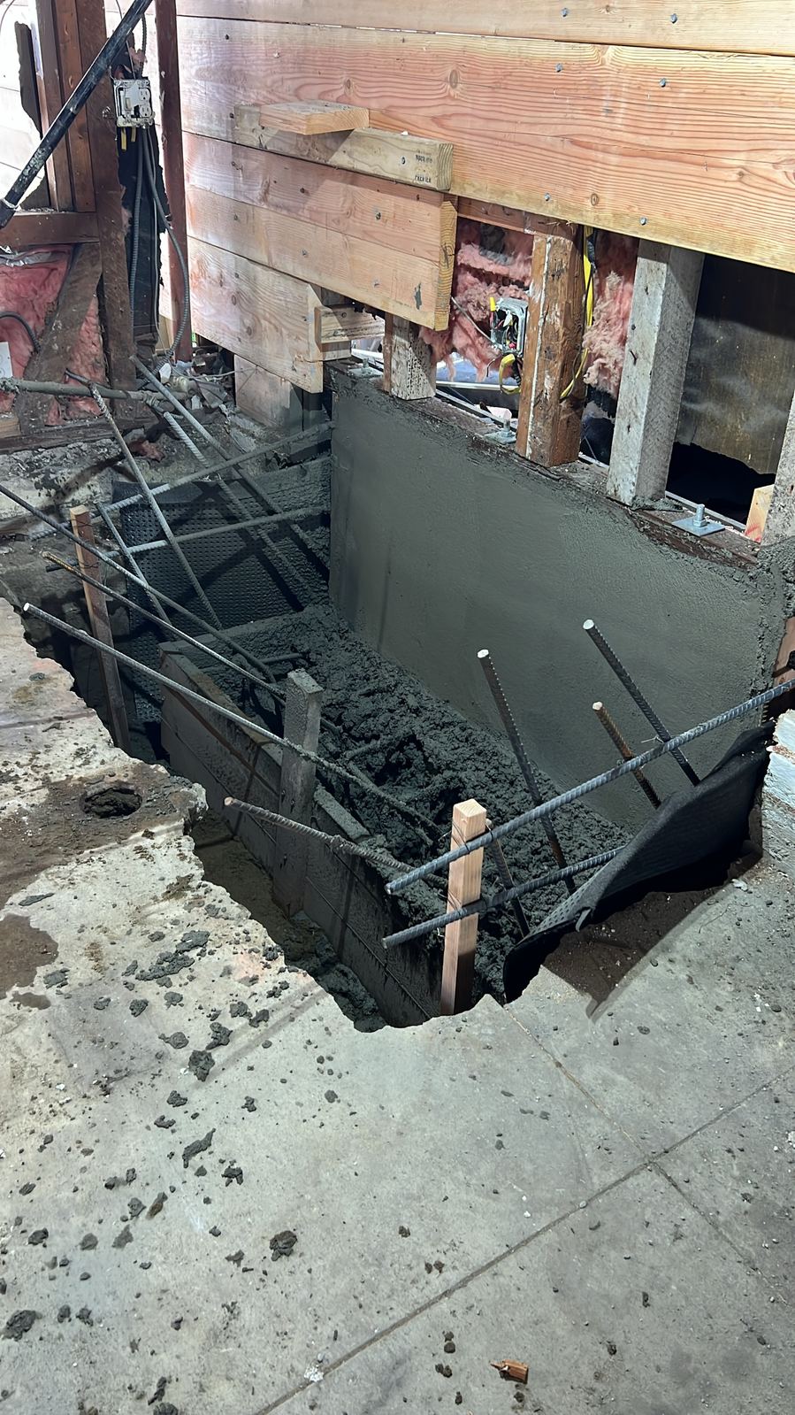 Freshly poured concrete foundation wall, still wet